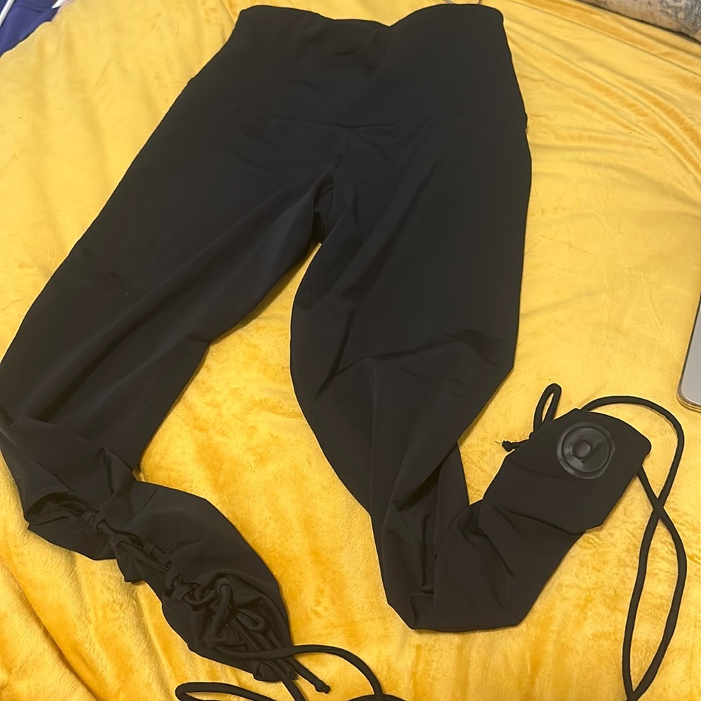 Pure Barre x Onzie black legging with open cross ties on calves